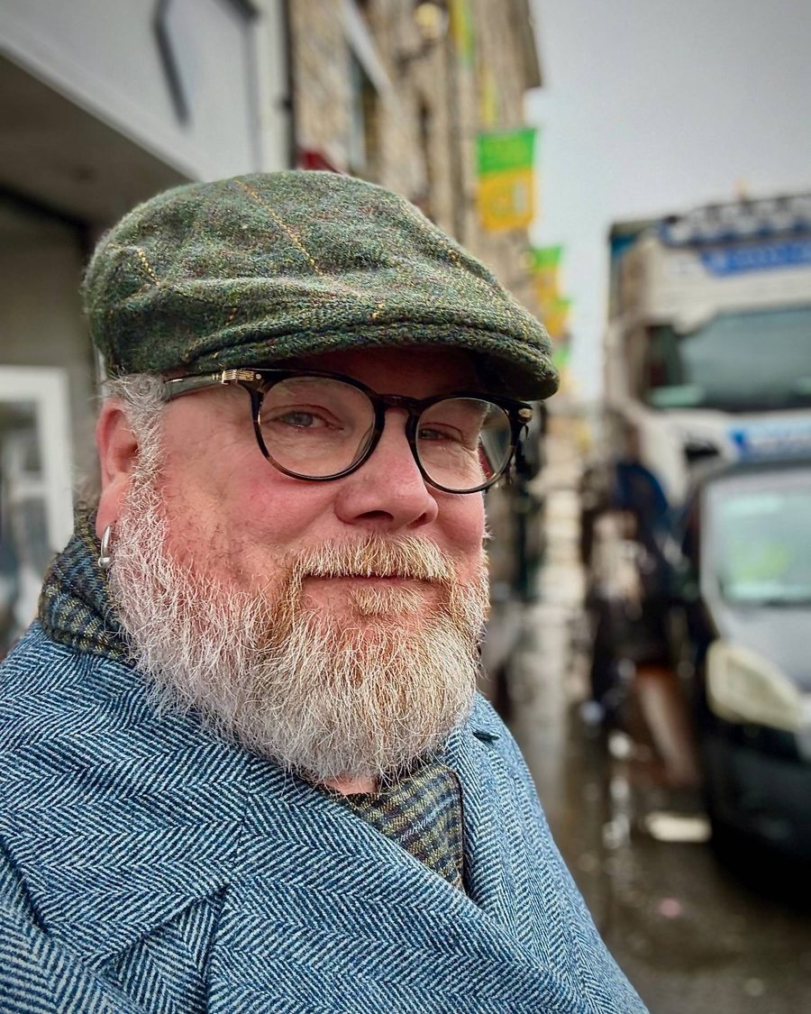 Jason O'Donnell in a tweed cap on an overcast street